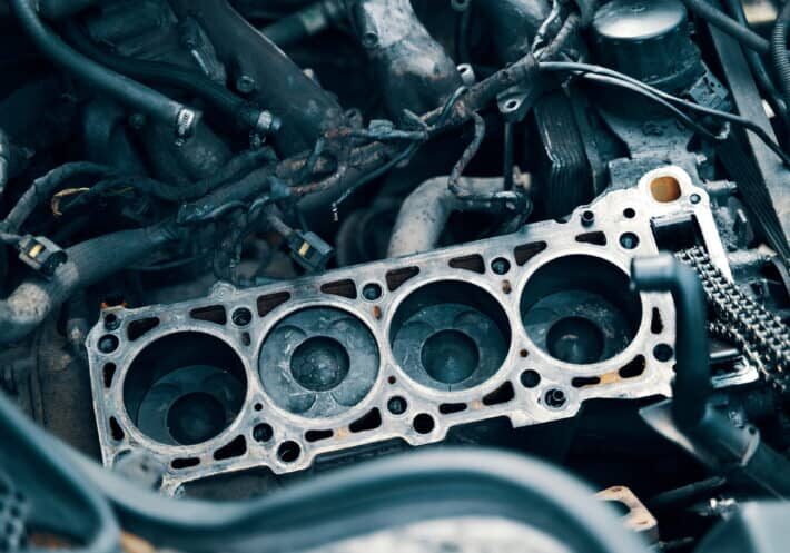 Auto mechanic working in garage. Repair service. The connecting rod, piston and cylinder block in a disassembled condition. maintenance repair at car service station for diagnosis. High quality photo